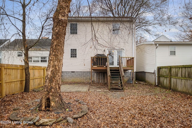 back of property with crawl space, a fenced backyard, stairs, and a wooden deck