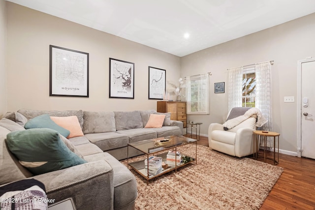 living room featuring baseboards and wood finished floors