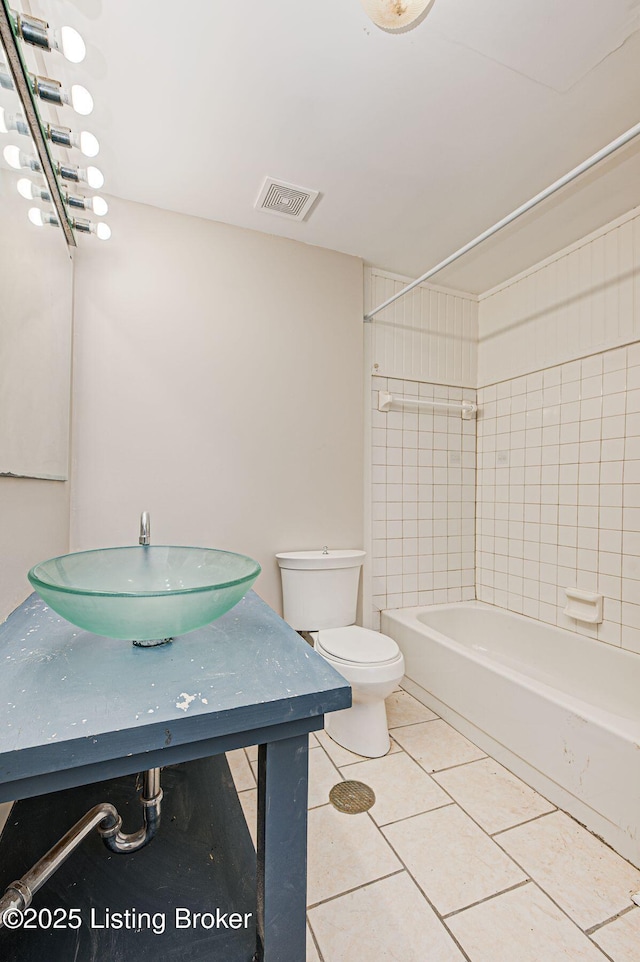 full bathroom featuring visible vents, toilet, washtub / shower combination, vanity, and tile patterned floors