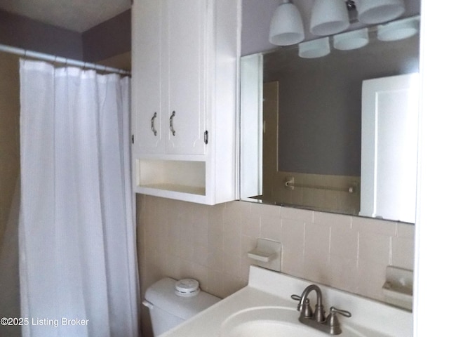 full bath featuring toilet, a shower with curtain, tasteful backsplash, and vanity