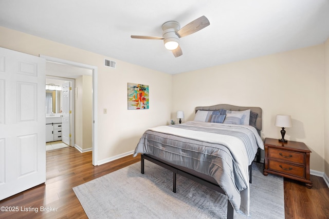 bedroom with a ceiling fan, wood finished floors, visible vents, and baseboards