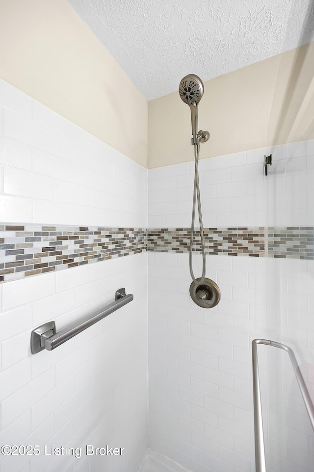 bathroom featuring a stall shower and a textured ceiling