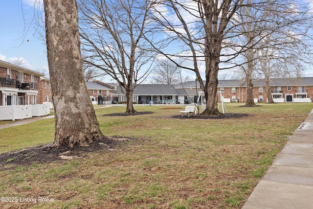 exterior space featuring a residential view and fence