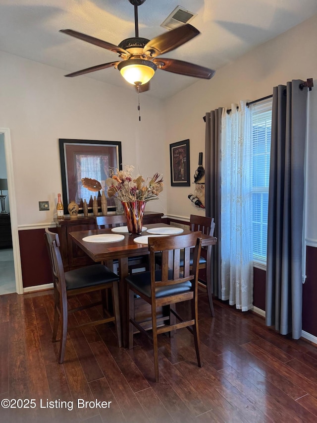 dining area with visible vents, ceiling fan, baseboards, and wood finished floors