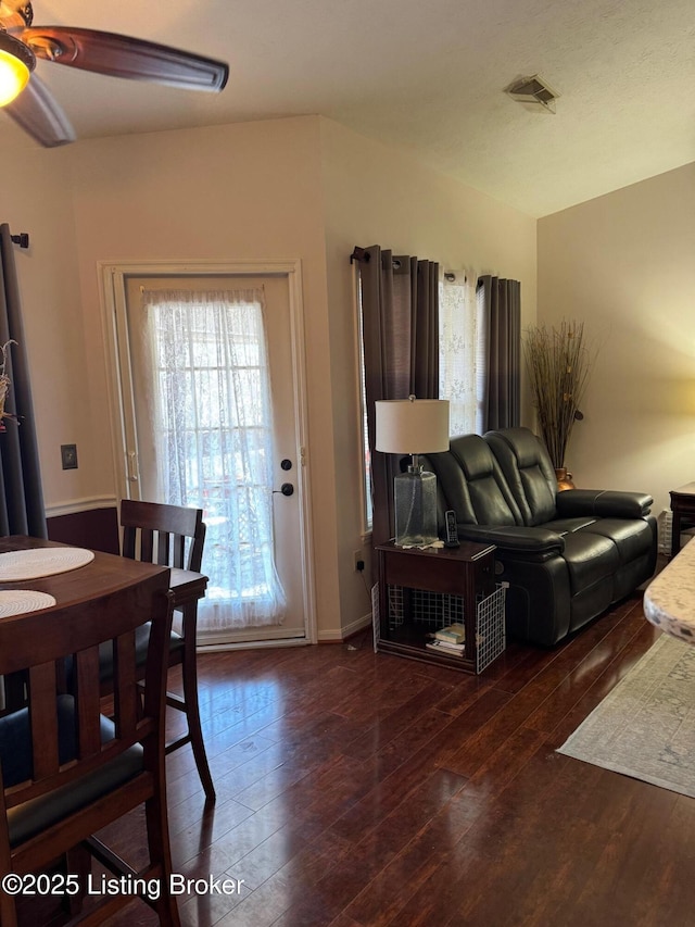 dining area with hardwood / wood-style flooring, ceiling fan, visible vents, and baseboards