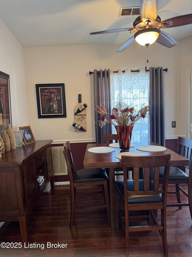 dining space featuring ceiling fan, wood finished floors, and visible vents