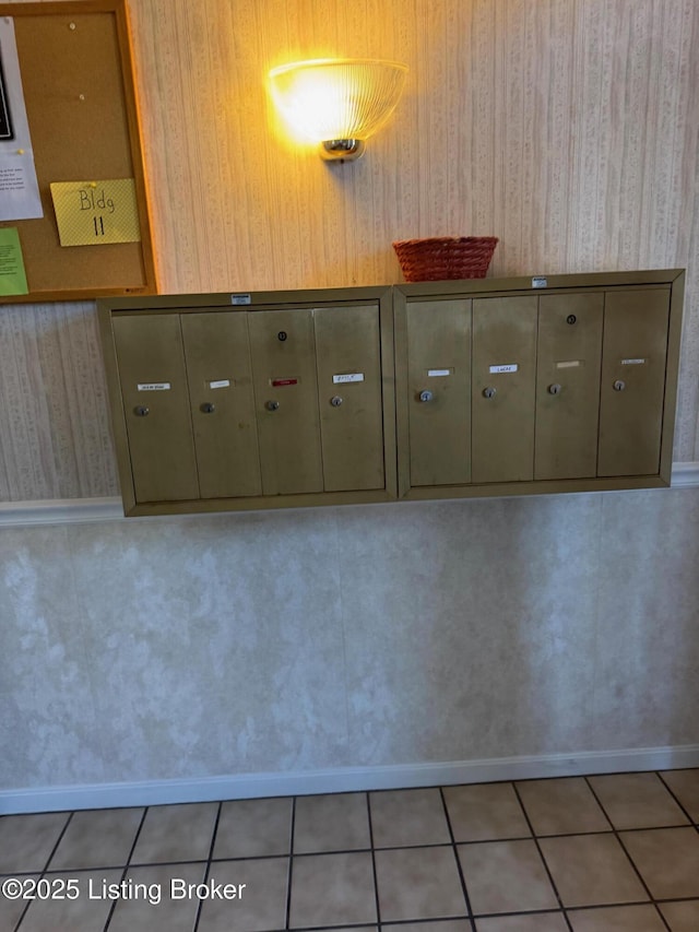 details with baseboards, mail area, and wallpapered walls