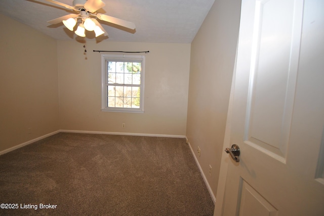 carpeted empty room with a ceiling fan and baseboards