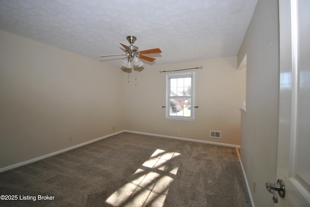 carpeted spare room featuring a textured ceiling, a ceiling fan, visible vents, and baseboards