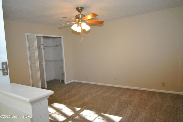 unfurnished bedroom featuring carpet, baseboards, and a closet