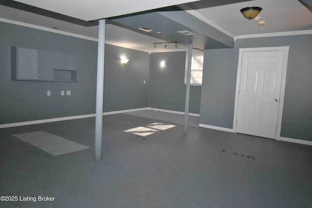 below grade area featuring ornamental molding and baseboards