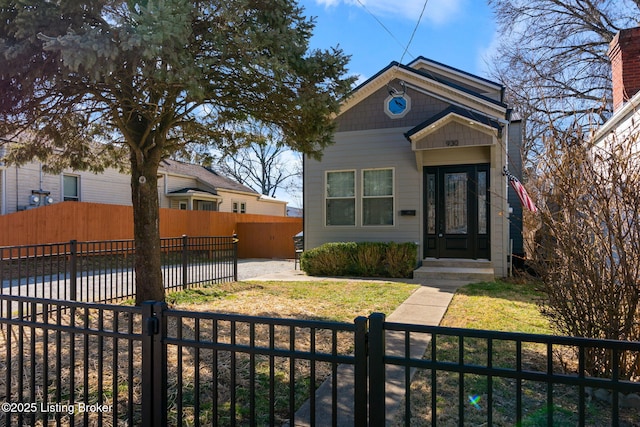 view of front facade with a fenced front yard and a gate