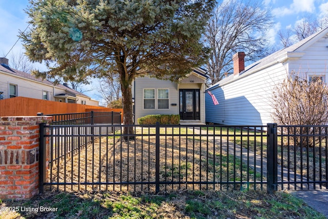 view of front of property with a fenced front yard and a gate