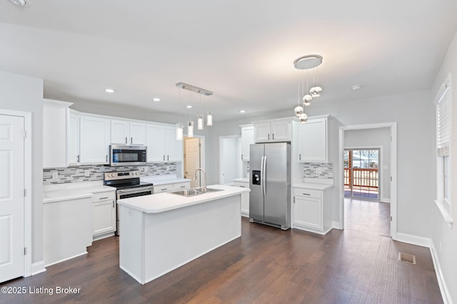 kitchen featuring light countertops, visible vents, appliances with stainless steel finishes, white cabinets, and a sink