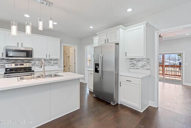 kitchen with white cabinetry, appliances with stainless steel finishes, light countertops, and a sink