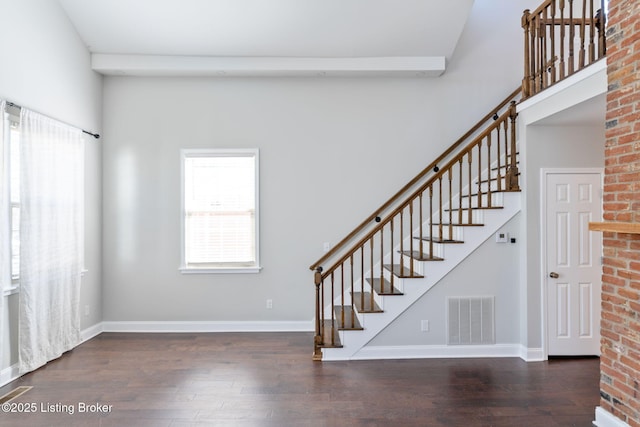 stairs featuring baseboards, visible vents, and wood finished floors