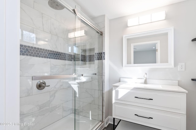 full bathroom with a stall shower and vanity