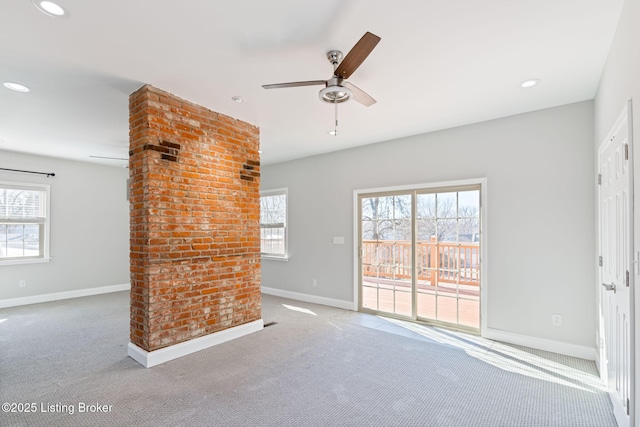 unfurnished living room with carpet, plenty of natural light, baseboards, and recessed lighting