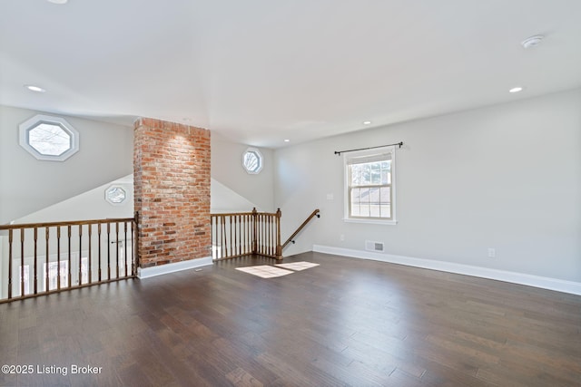 empty room with recessed lighting, wood finished floors, visible vents, and baseboards