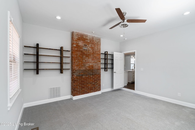 carpeted empty room featuring plenty of natural light, visible vents, and recessed lighting