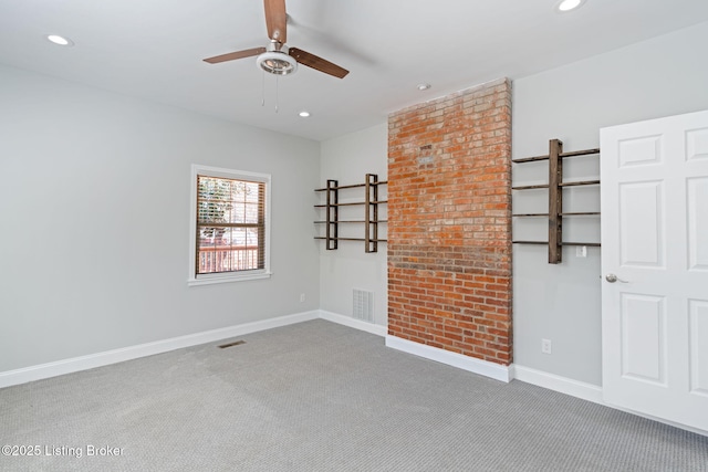 carpeted empty room featuring baseboards, visible vents, and recessed lighting