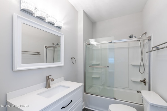 full bath with toilet, shower / bath combination with glass door, and vanity