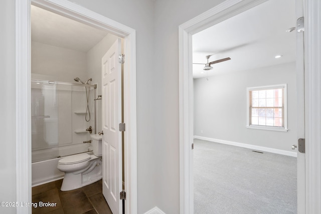 full bath with visible vents, baseboards, a ceiling fan, toilet, and enclosed tub / shower combo