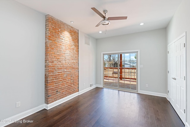 spare room with dark wood-type flooring, recessed lighting, visible vents, and baseboards