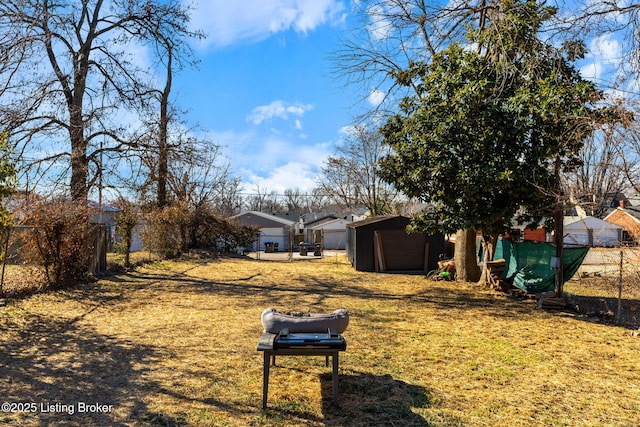 view of yard featuring fence and an outdoor structure