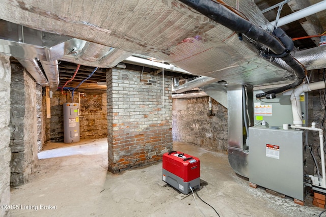 unfinished below grade area featuring electric water heater and heating unit