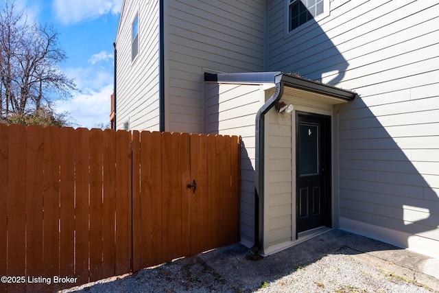 view of side of home featuring fence