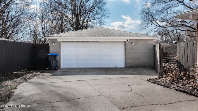 detached garage featuring fence