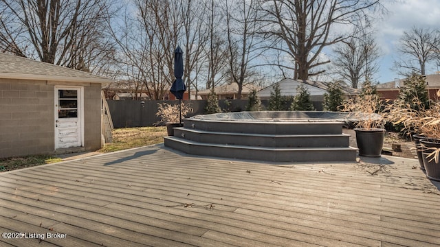 deck with a fenced backyard