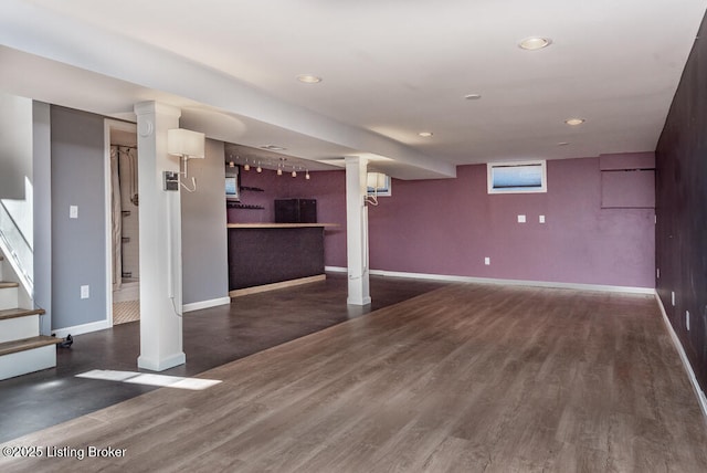 basement with stairs, recessed lighting, baseboards, and wood finished floors