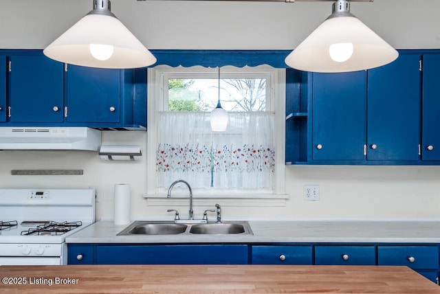 kitchen featuring range hood, light countertops, white gas stove, blue cabinetry, and a sink