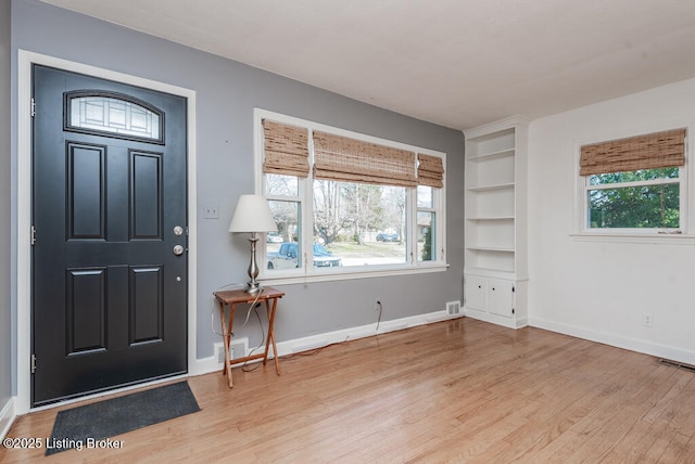 entrance foyer featuring light wood finished floors, visible vents, and baseboards