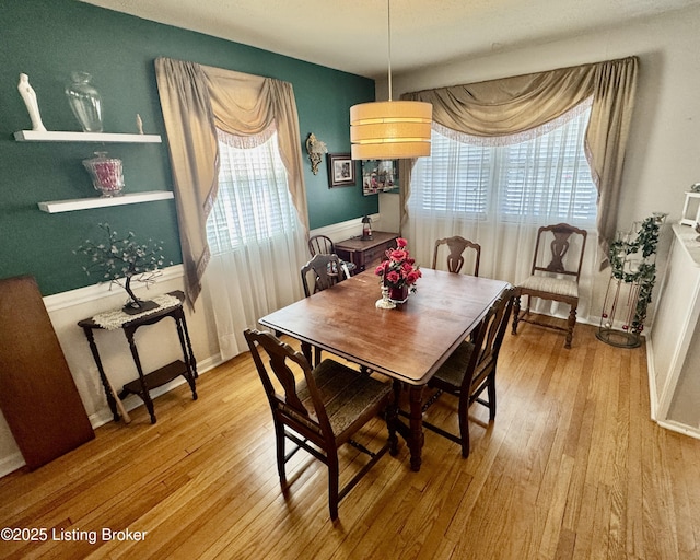 dining room with hardwood / wood-style flooring and baseboards