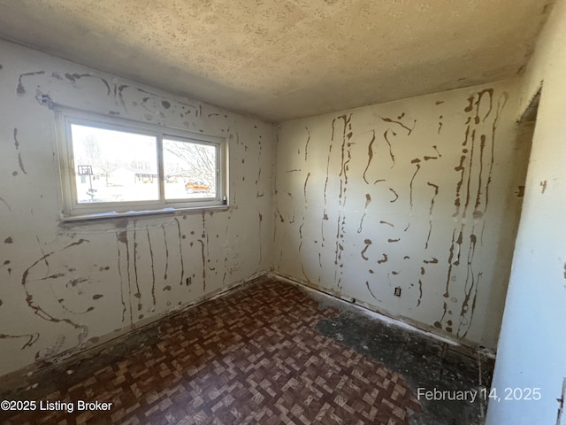 spare room featuring a textured ceiling