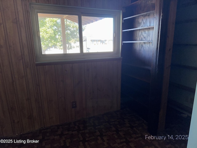 empty room featuring wooden walls