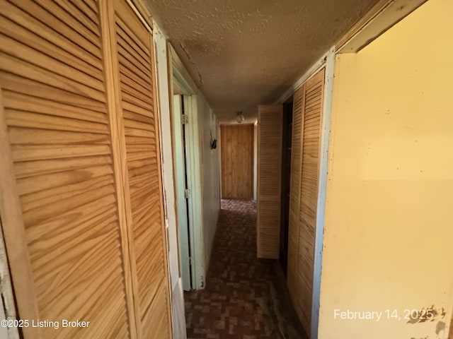 corridor with a textured ceiling