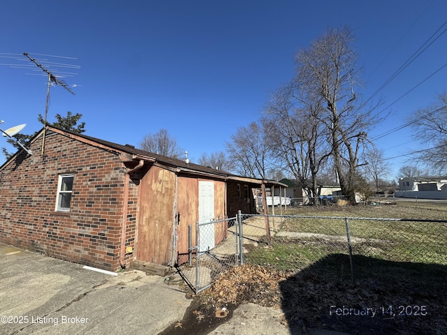 view of property exterior featuring brick siding and fence