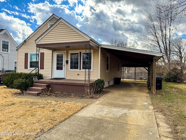 view of front of property with driveway, a porch, and an attached carport