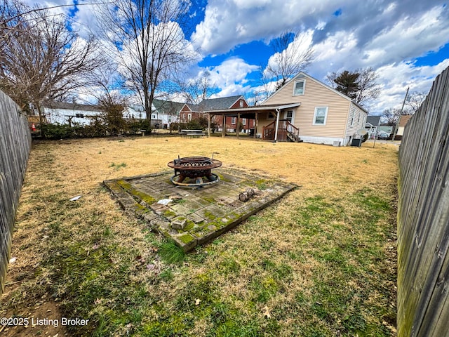 view of yard featuring fence and a fire pit