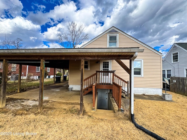 rear view of property with fence