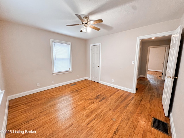 unfurnished bedroom featuring light wood-style flooring, visible vents, and baseboards