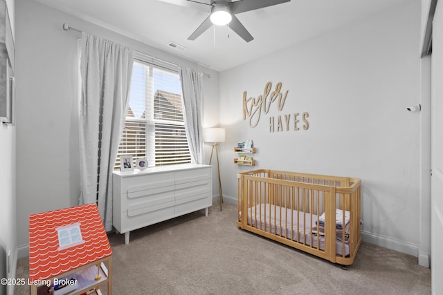 bedroom with a nursery area, carpet, visible vents, and baseboards