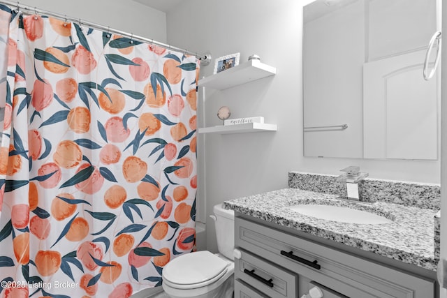 bathroom featuring toilet, a shower with curtain, and vanity