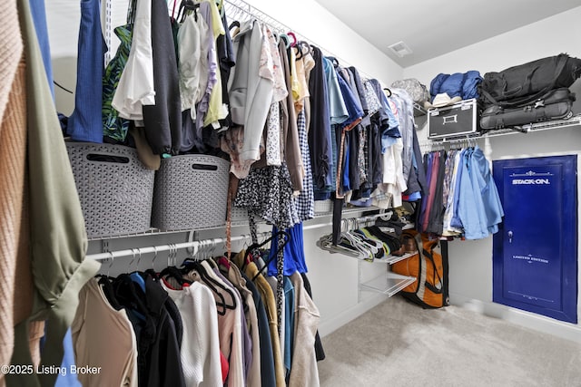 walk in closet with carpet flooring