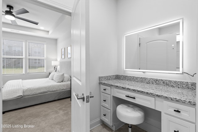 bedroom featuring light carpet and built in study area