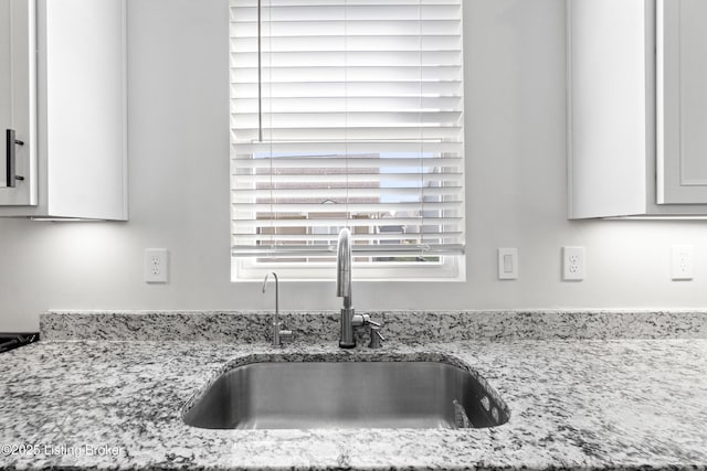 details with light stone counters and a sink